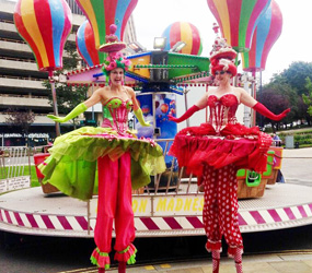 Festival Entertainment - CRAZY RAINBOW CAKE STILTS TO BOOK FOR WONDERLAND THEMED PARTIES UK