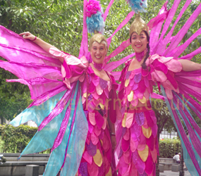 PINK PARADISE BIRD STILTS - COLOURFUL FESTIVAL THEMED PERFORMERS HIRE 