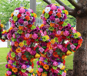 Festival Themed Entertainment - Flower Men Blossom in hugs - fun interactive festival fun acts to hire