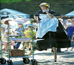Royal Jubilee themed entertainment - The Royal Tea Lady Stilt act hire with her musical tea trolley 